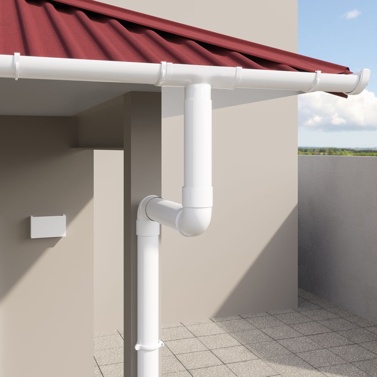 White PVC rain gutter and downpipe fitted under a red roof edge